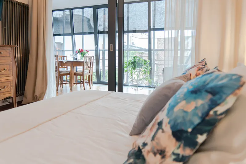Bed and cushions with the glazed part of the apartment behind — Deluxe Apartment, Hornigold